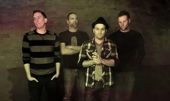 Mike singing on stage with his band.